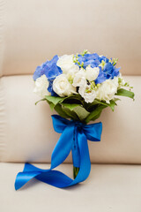 Bride's bouquet in blue and white colors with a big blue bow. vertical template stories