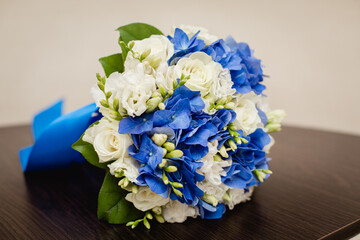 Bride's bouquet in blue and white colors with a big blue bow. vertical template stories