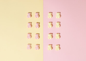 Pattern of marshmallow candy bears on a pink-yellow background. Minimal flat lay concept