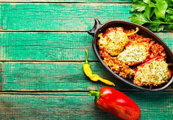 Stuffed peppers with meat on wooden background