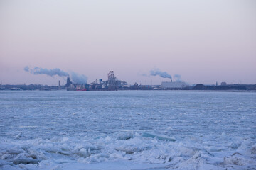 Ice on the St. Lawrence River with the industrial part of the Quebec City old port seen from the...