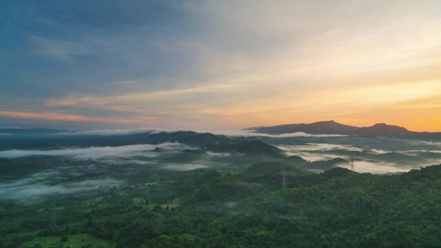 Time lapse video 4k motion, Aerial view Beautiful of morning scenery Golden light sunrise And high voltage power the mist flows on high mountains. Pang Puai, Mae Moh, Lampang, Thailand. 