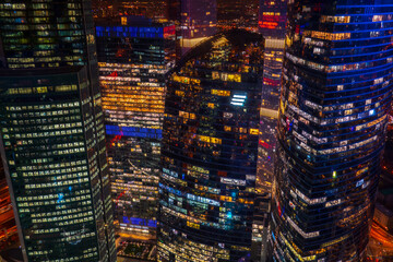Fototapeta na wymiar Illuminated skyscrapers in night city