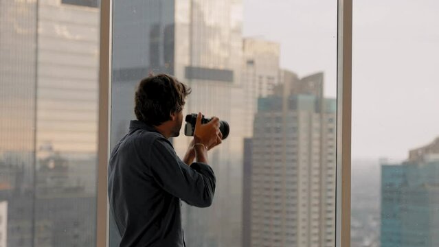 Long Shot of Man Taking Photos in Window