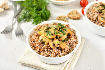 Buckwheat porridge with roasted mushrooms in white bowl.
