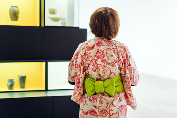 Japanese woman in kimono. No face, back view. Asian traditional clothes.
