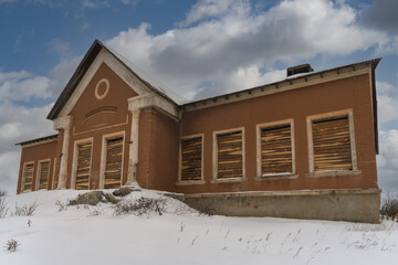 A dilapidated ancient rural church (Kashina, Ural, Russia) with a rich history on a winter day. The Russian writer Bazhov P.P. was married in it. House on a snowy hill 