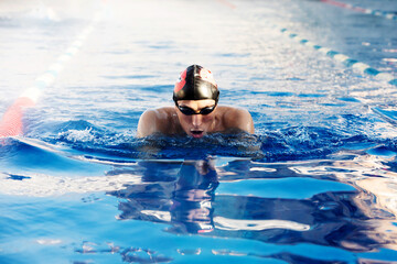 Professional male swimmer swimming in the pool