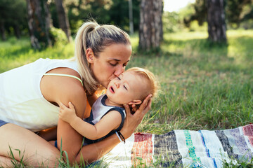 mother kissing her son outdoor