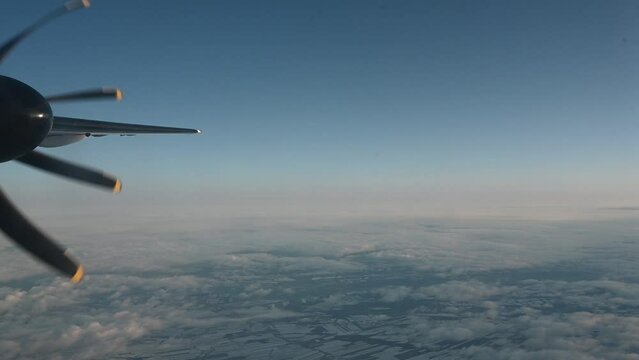Propeller Airplane Engine Spins Over The Slightly Clouded Horizon Of A Rural Area. 