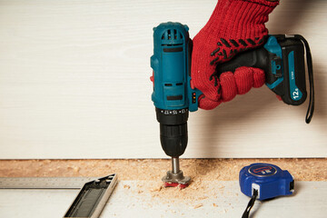 Installation of furniture hinges in the kitchen cabinet door. Tools and furniture fittings needed to replace hinges. Workplace-workshop