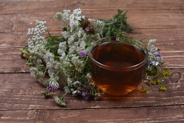 Cup of herbal tea with various herbs