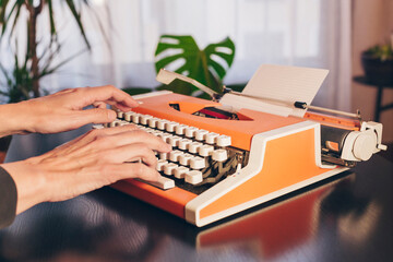 Writer's hands on retro typewriter. Concept classic literature