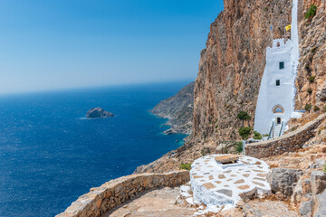 The famous Hozoviotissa Monastery standing on a rock over the Aegean sea in Amorgos island, Cyclades, Greece. - obrazy, fototapety, plakaty