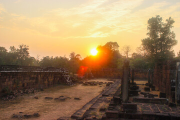 Orange sunrise sky over Angkor Wat ruins