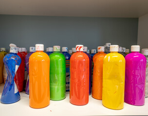 Plastic bottles filled with watercolor paint in bright colors - 484414059