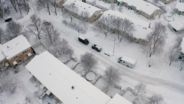 Espoo Finland. February 1, 2022 Drone follows the car. Cars, streets, houses, trees are covered with snow. View of the winter city. drone photo
