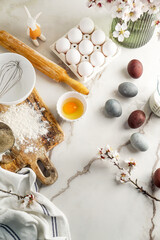 Easter culinary background. Easter food ingredients composition on the kitchen table and copy space for a text menu or recipe