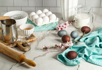 Easter culinary background. Easter food ingredients composition on the kitchen table and copy space for a text menu or recipe