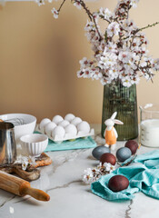 Fototapeta na wymiar Easter culinary background. Easter food ingredients composition on the kitchen table and copy space for a text menu or recipe