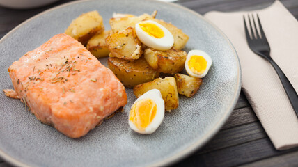 steamed salmon fillet with potato wedges and quail egg