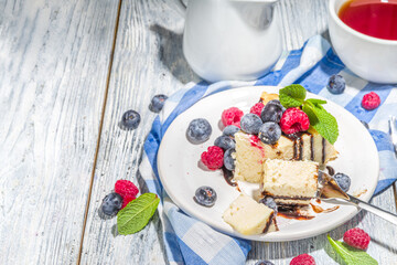 Classic cheesecake with chocolate topping and fresh berries, homemade cheesecake for summer breakfast 