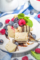 Classic cheesecake with chocolate topping and fresh berries, homemade cheesecake for summer breakfast 