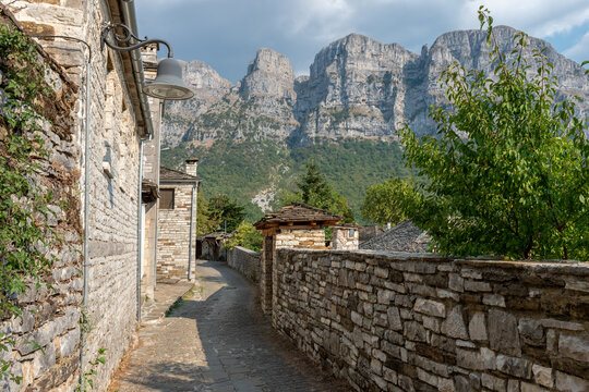 view of traditional architecture  with   stone buildings and background astraka mountain during  fall season in the picturesque village of papigo , zagori Greece