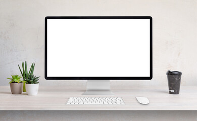 Computer display on work desk with white, isolated screen for web page presentation