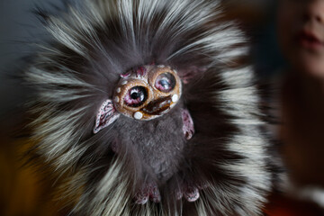 Cute baby toddler girl with fluffy funny fur toy. Homemade toys for children, favorite toys