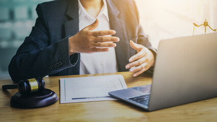 Lawyers consult online via video conferencing system by laptop.