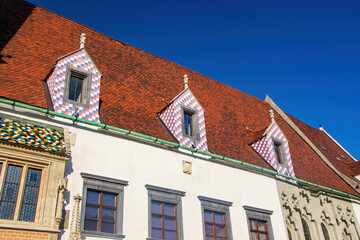 Fototapeta na wymiar Tiled Roof with Colourful Checkered Dormers of Old Town Hall in Bratislava, Slovakia