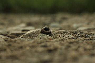 The screw lies in the dust on the road