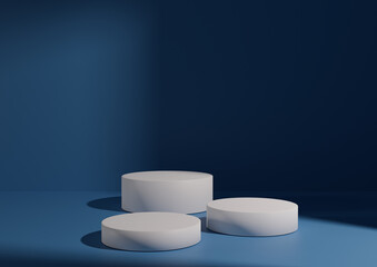 Three white podiums or stands on cobalt blue background for product display. Minimal composition for product display 3D rendering mockup. Window light coming from right side.