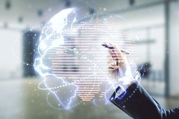 Double exposure of man hand with pen working with abstract digital world map hologram with connections on blurred office background, big data and blockchain concept