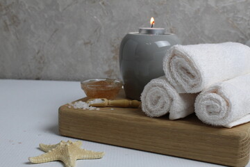 Fototapeta na wymiar spa massage relax. Towels scrub salt candles with space for text copyspace
