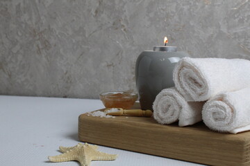 Obraz na płótnie Canvas spa massage relax. Towels scrub salt candles with space for text copyspace