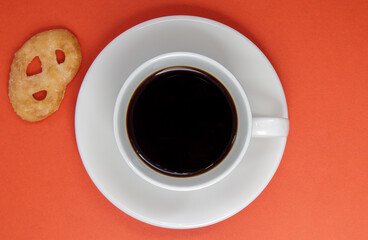 Black coffee in a white coffee cup on a bright background. Top view, flat lay, copy space. Cafe and bar, barista art concept. Freshly made natural or instant coffee in a cup. Coffee background.