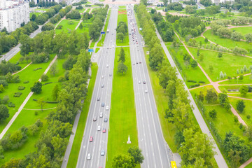 Fototapeta na wymiar Aerial view of the highway. Straight two-way road through the park.