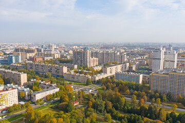 Autumn city park among apartment buildings from a height.