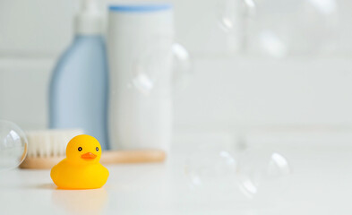 Baby bath accessories. Child care. Miniature yellow rubber duckling for bathing with a brush and...