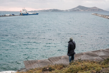 Fototapeta na wymiar man looking at cloudy curtain sea greece island