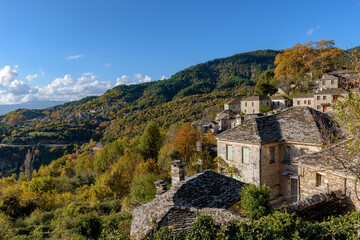 Fototapeta na wymiar View of the traditional village Mikro Papigo with with the famous stone buildings during fall season in zagori Greece