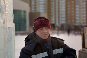 Portrait of a fitter in a blue jacket at a construction site