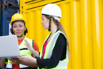 Commercial docks Inspector with white hard hat and Foreman woman wearing protective clothing working, checking container cargo harbor to loading containers. Warehouse shipping transportation concept.