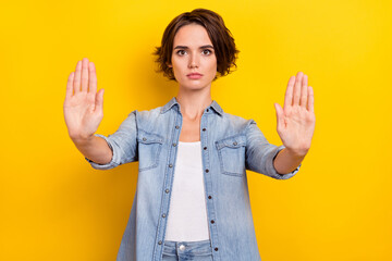 Photo of young lady show palms no refuse rejection sign enough isolated over yellow color background