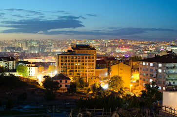 Obraz premium Scenic aerial night light landscape view of Ankara. Illuminated high-rise buildings on the horizon. View from the hill near Ankara Castle. Travel and tourism concept