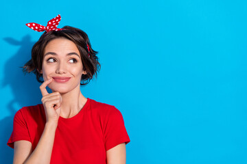 Photo of young lovely woman good mood curious dream think look empty space isolated over blue color...