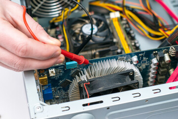 the master repairs the old computer checks the chips with a multimeter