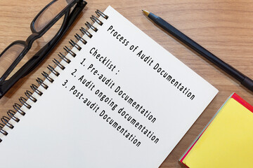 Text on notepad with yellow note and study glasses. Accounting concept